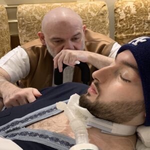 Sleeping Prince Al-Waleed bin Khalid Al Saud lying in hospital bed under medical care